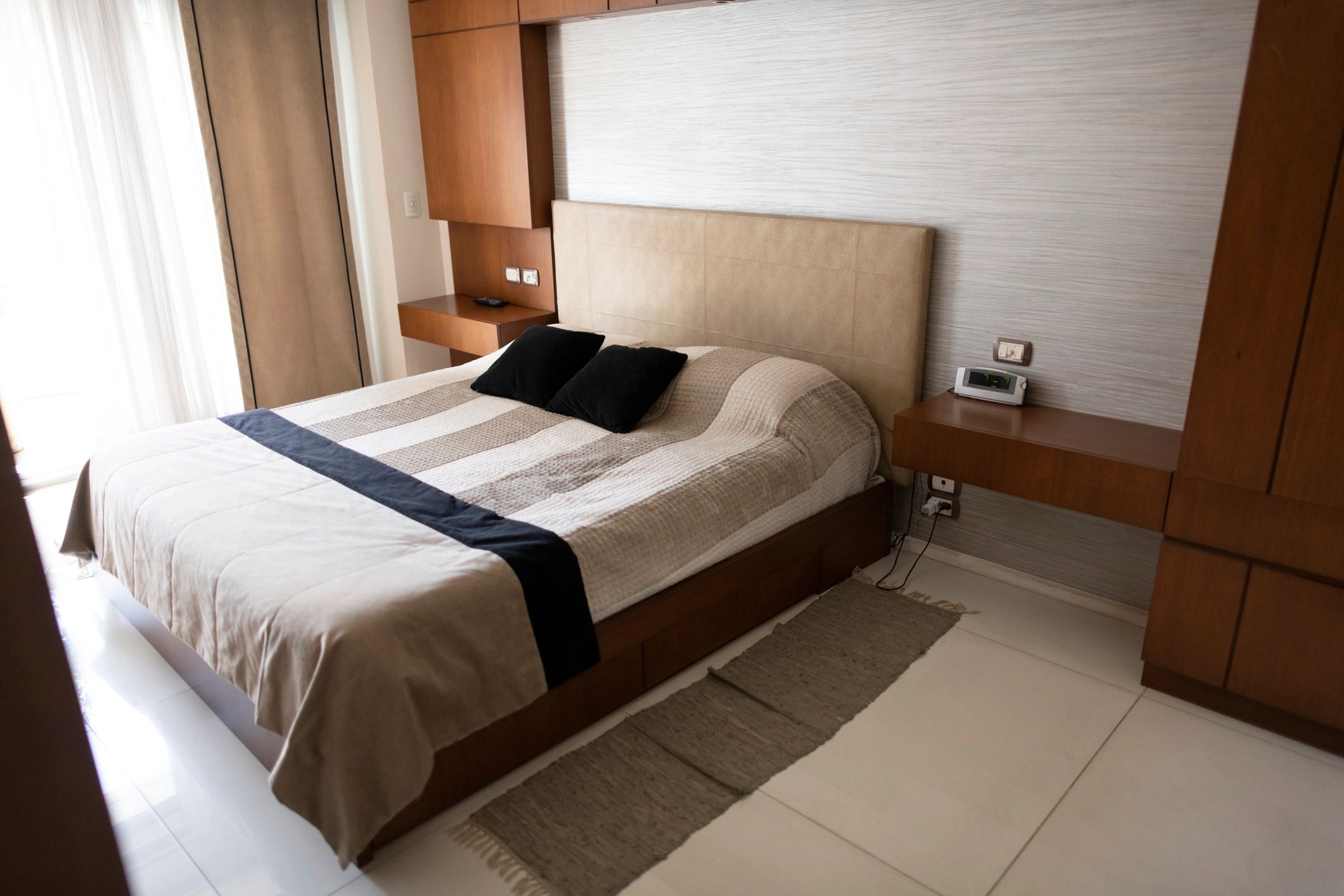 Modern bedroom with a designer bed in neutral tones